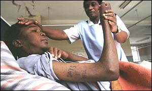 A nurse attends an Aids patient in Zambia