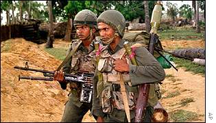 Sri Lankan soldiers armed with a mortar launchers and machine guns 