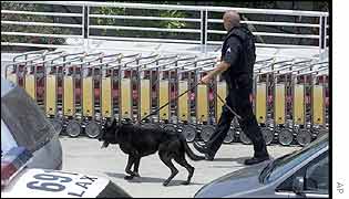 Police officer with dog patrols LA airport after shooting