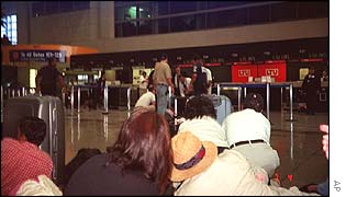 Guards examined the body of the dead gunman as passengers look on