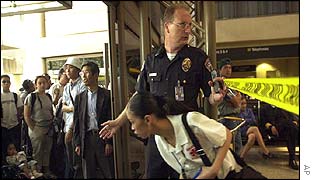 Police officer evacuates passengers and airport workers from the airport