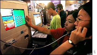 Chinese people using an online phone at a computer exhibition in Beijing 