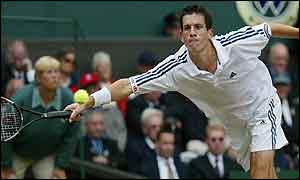 Henman tries to return another Hewitt shot