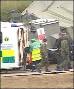 An injured officer is taken to hospital