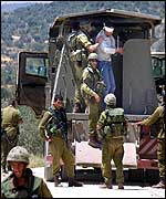 Israeli troops in Salfit put a detainee into an army truck