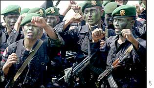 Indonesian soldiers raise their fists as they sing during an exercise in Jatiluhur, West Java