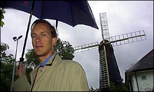 English Heritage's Dr Simon Thurley next to at-risk Brixton Windmill