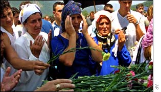 Women praying and laying flowers at Srebrenica
