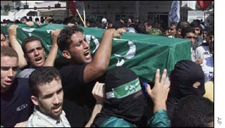 Mourners with a coffin draped with the Hamas flag