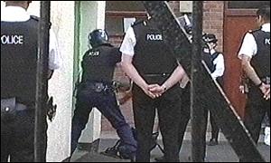 Police officers break into the mosque