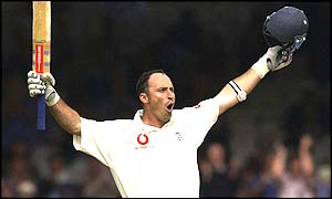 Nasser Hussain  raises his bat after reaching his century against India at lord's