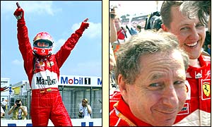 Schumacher raises his arms in triumph at winning pole position and celebrates with  Jean Todt