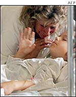 A boy is attended to by his grandmother at the reanimation department at the children's hospital in  Lviv