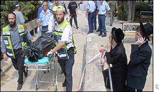 A victim's body is removed from the scene