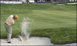 Graeme McDowell chips out of a bunker
