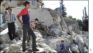 Palestinian children survey the debris of militant's demolished home
