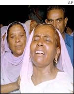Grieving relatives at the scene of the attack on  a missionary hospital