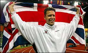 Steve Backley celebrates with the Union Jack flag after his victory
