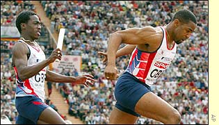 Britain's Christian Malcolm hands over to Darren Campbell in the 4x100m semi-final