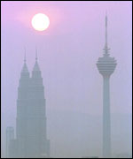 Sun, skyscrapers in haze   AP