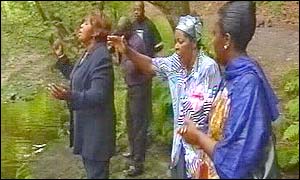 Herve Bola's family hold prayers at the pool where he drowned
