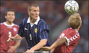 Kevin Kyle (left) sends a header towards the Danish goal
