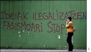 Passer-by walks past a wall painting which says (in Basque)  'Ban on ideas, stop fascism', in Tolosa, northern Spain