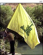 Hezbollah flag being planted on the Lebanese side of the Wazzani river