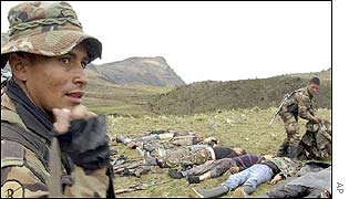 Colombian soldiers stand guard near to bodies of FARC rebels after an operation to free civilians  kidnapped by the insurgents