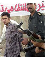 Amir Karbalai (l) being led to execution
