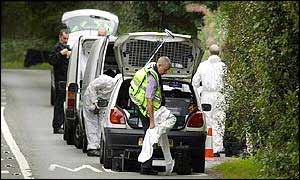 Police prepare to search the woodland site