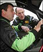 Gwyndaf Evans gives Mark Blundell some tips as he sits in his MG ZR  