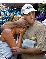 Stuart Cram comforts his sister Tia Byron from Sydney, Australia, who is the mother of  a 14-year-old victim Chloe Byron