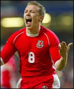 Craig Bellamy celebrates scoring the winner for Wales