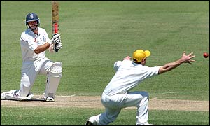 England captain Nasser Hussain drives the ball past an Australian fielder 