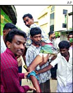 A Muslim being carried out of a troubled area