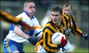 Crfossmaglen's John McEntee (right)  breaks clear from Damian McDermott