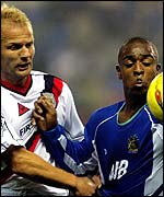 Wigan striker Nathan Ellington fends off the attention of Manchester City defender Gerard  Wiekens