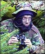 Man in camouflage gear with Christmas trees