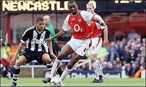 Patrick Vieira shields the ball from Jermaine Jenas during the first half at Highbury