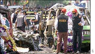 Investigators at the site of the Bali bombing, surrounded by flowers laid in memory of the dead