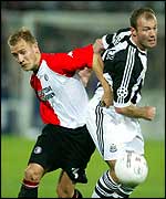 Alan Shearer takes on Feyenoord's Tomasz Rzasa