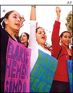 Turkish Cypriot girls hold banners reads: Peace now and Peace during a demonstration in  Nicosia