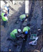 Workers excavating the ship