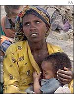 Mother and child at a feeding station in Angola  