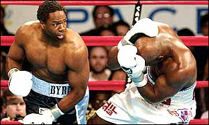 Evander Holyfield  ducks for cover in the face of an onslaught from Chris Byrd