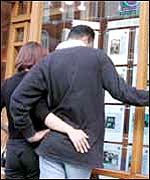Couple looking in an estate agents window