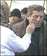 A woman cleans blood off a man's face after the bombing in Grozny.  Picture: TVS television channel