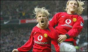 David Beckham helps Diego Forlan celebrate