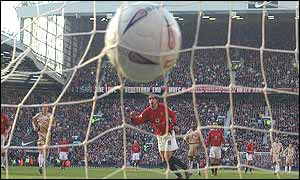 Ruud van Nistelrooy scores a penalty against Portsmouth
